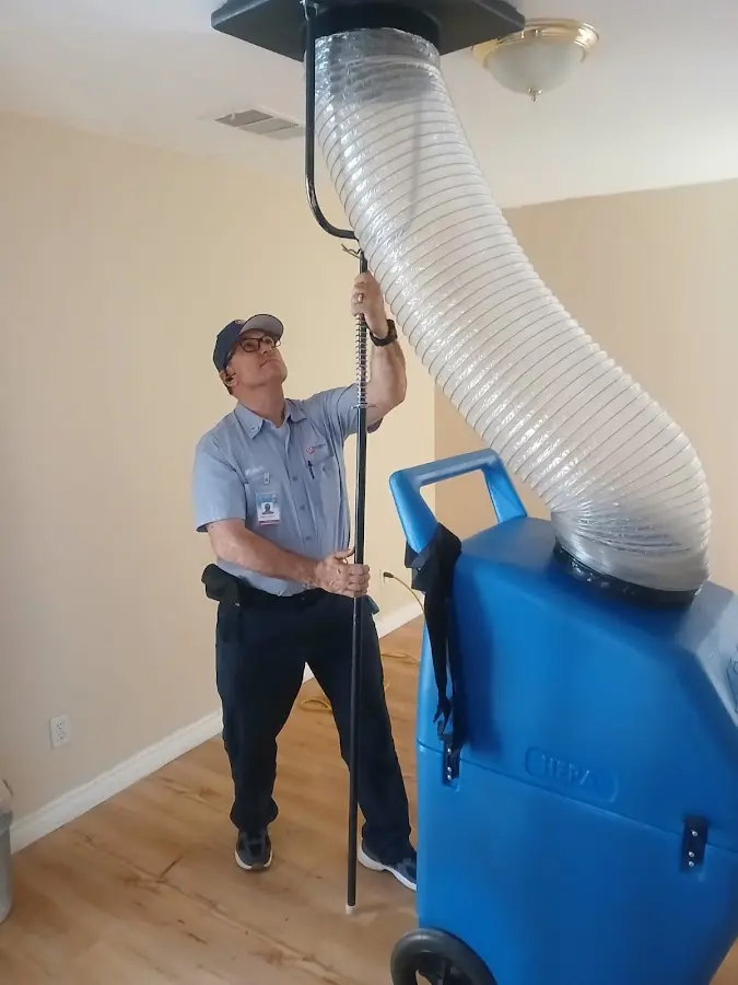 Furnace Tune-Up technician using HEPA equipment in Huntley